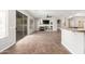 Open-concept living room with sliding glass doors, a fireplace, and a bar overlooking the kitchen at 4215 W Hackamore Dr, Phoenix, AZ 85083