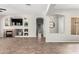 Open living room featuring a fireplace, built-in shelving, and neutral decor at 4215 W Hackamore Dr, Phoenix, AZ 85083