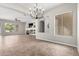 Spacious living room with neutral walls, tile flooring, and built-in shelving for decor and entertainment at 4215 W Hackamore Dr, Phoenix, AZ 85083