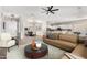 Open-concept living room featuring a modern kitchen, dining area, and comfortable seating at 4215 W Hackamore Dr, Phoenix, AZ 85083
