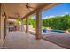 Covered patio overlooking the lush backyard and the inviting pool with waterfall feature at 4215 W Hackamore Dr, Phoenix, AZ 85083