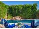Relaxing poolside with a rock waterfall feature and seating for two at 4215 W Hackamore Dr, Phoenix, AZ 85083