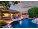 Inviting backyard pool and patio featuring a rock waterfall and an outdoor living space at 4215 W Hackamore Dr, Phoenix, AZ 85083