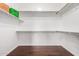 Walk-in closet featuring shelving with dark wood-look flooring at 4215 W Hackamore Dr, Phoenix, AZ 85083