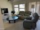 Comfortable living room with reclining sofa, large windows, and neutral carpet at 4301 E Amberwood Dr, Phoenix, AZ 85048