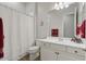 Well-lit bathroom with a white vanity, framed mirror, and shower-tub combination, offering functionality and style at 4426 E Leroy St, Gilbert, AZ 85295