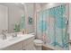 Cozy bathroom with a patterned shower curtain, neutral walls, and a well-lit vanity area, providing a comfortable space at 4426 E Leroy St, Gilbert, AZ 85295