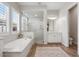 Relaxing bathroom featuring a soaking tub, walk in shower, and ample vanity storage at 4426 E Leroy St, Gilbert, AZ 85295