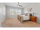 Main bedroom featuring carpet, plantation shutters, ceiling fan and night stands at 4426 E Leroy St, Gilbert, AZ 85295