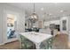 Charming dining area with stylish chandelier, views of the outdoor patio, and seamless access to the kitchen at 4426 E Leroy St, Gilbert, AZ 85295