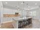 Spacious kitchen with breakfast bar, stainless steel appliances, and designer lighting at 4426 E Leroy St, Gilbert, AZ 85295