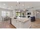 Modern open-concept kitchen with granite island, pendant lighting, and seamless flow to the dining and living areas at 4426 E Leroy St, Gilbert, AZ 85295