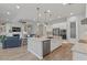 Modern kitchen with stainless appliances, granite counters, pendant lighting, and open floorplan at 4426 E Leroy St, Gilbert, AZ 85295