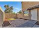 View of brick-paved backyard area with grass, mulch, and block-wall enclosure at 4714 E Broadway Rd, Phoenix, AZ 85040