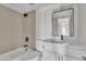 Modern bathroom featuring a soaking tub, stylish vanity, and tiled walls at 4714 E Broadway Rd, Phoenix, AZ 85040