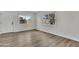 Bedroom features wood-look flooring, white trim, and bright windows with security bars at 4714 E Broadway Rd, Phoenix, AZ 85040
