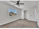 Bedroom featuring a window view to the outside, plus closet and fan at 4714 E Broadway Rd, Phoenix, AZ 85040