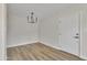 Modern dining room featuring wood floors, neutral paint, and a modern chandelier at 4714 E Broadway Rd, Phoenix, AZ 85040