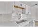 Bright kitchen featuring white cabinets, subway tile backsplash, and stainless steel sink at 4714 E Broadway Rd, Phoenix, AZ 85040