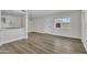 Modern living room featuring wood floors, access to kitchen and a bright, welcoming entrance at 4714 E Broadway Rd, Phoenix, AZ 85040