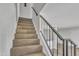 Carpeted staircase leading to the upper level of the home at 4714 E Broadway Rd, Phoenix, AZ 85040