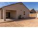 Backyard featuring desert landscaping, a covered patio, a small plant, and a view of the home's exterior at 6999 S Blue Hills Dr, Buckeye, AZ 85326