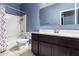 Well-lit bathroom featuring a shower-tub combination and dark wood vanity at 6999 S Blue Hills Dr, Buckeye, AZ 85326
