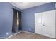 A bedroom with gray-blue walls, a window, carpet and a closet at 6999 S Blue Hills Dr, Buckeye, AZ 85326