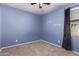 A cozy empty bedroom with carpet, natural light, and neutral paint at 6999 S Blue Hills Dr, Buckeye, AZ 85326