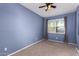 Cozy bedroom with carpet flooring, a ceiling fan, window, and neutral decor at 6999 S Blue Hills Dr, Buckeye, AZ 85326