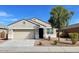 Charming single-story home featuring a low maintenance landscape, two-car garage, and neutral color palette at 6999 S Blue Hills Dr, Buckeye, AZ 85326