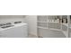 A well-equipped laundry room with ample storage shelves and modern washer and dryer units at 6999 S Blue Hills Dr, Buckeye, AZ 85326
