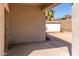 Covered patio area featuring an exterior wall, a small patio area, and a view of the backyard and shed at 6999 S Blue Hills Dr, Buckeye, AZ 85326