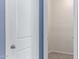 An empty walk-in closet with neutral walls, carpet flooring, and a white door in need of a new coat of paint at 6999 S Blue Hills Dr, Buckeye, AZ 85326