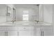 Bathroom with dual sinks, white marble countertop, and chrome fixtures at 7376 E Via Estrella Ave, Scottsdale, AZ 85258