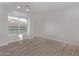 Bedroom with wood-look floors, neutral walls, and a window with blinds at 7376 E Via Estrella Ave, Scottsdale, AZ 85258