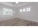 Bright bedroom with three windows and wood-look floors offering ample natural light at 7376 E Via Estrella Ave, Scottsdale, AZ 85258