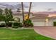 Stunning home featuring a well-manicured lawn, desert landscaping, and a three-car garage at 7376 E Via Estrella Ave, Scottsdale, AZ 85258