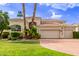Beautiful home with a three-car garage and manicured lawn, capturing curb appeal at 7376 E Via Estrella Ave, Scottsdale, AZ 85258