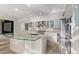 Modern kitchen with stainless steel appliances, sleek cabinetry, and a unique glass breakfast bar at 7376 E Via Estrella Ave, Scottsdale, AZ 85258