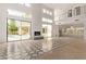 Spacious living room featuring a fireplace, high ceilings, and large sliding doors to the pool area at 7376 E Via Estrella Ave, Scottsdale, AZ 85258