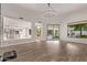 Open-concept living area featuring wood flooring, neutral walls, and access to the pool area at 7376 E Via Estrella Ave, Scottsdale, AZ 85258