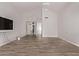 Spacious living room with wood-look floors and view into the main bathroom at 7376 E Via Estrella Ave, Scottsdale, AZ 85258