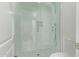 Walk-in shower featuring white subway tile, rainfall showerhead, and glass door at 7376 E Via Estrella Ave, Scottsdale, AZ 85258