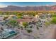 Desert home's aerial view showcasing a tiled roof, desert landscaping, and backyard swimming pool at 8139 E Club Village Dr, Gold Canyon, AZ 85118