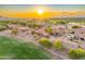 Aerial view of desert homes with red tile roofs and a golf course in the background at 8139 E Club Village Dr, Gold Canyon, AZ 85118