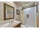 Well-lit bathroom with white tile walls, neutral colored floors, and a shower with a cream-colored curtain at 8139 E Club Village Dr, Gold Canyon, AZ 85118