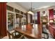 Elegant dining room with a large wooden table, decorative lighting, and access to the outdoor patio at 8139 E Club Village Dr, Gold Canyon, AZ 85118