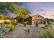 Charming desert home with a well-manicured front yard, mature trees, and a two-car garage at 8139 E Club Village Dr, Gold Canyon, AZ 85118