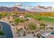 Aerial view of the property and surrounding neighborhood with golf course and mountain views at 8139 E Club Village Dr, Gold Canyon, AZ 85118